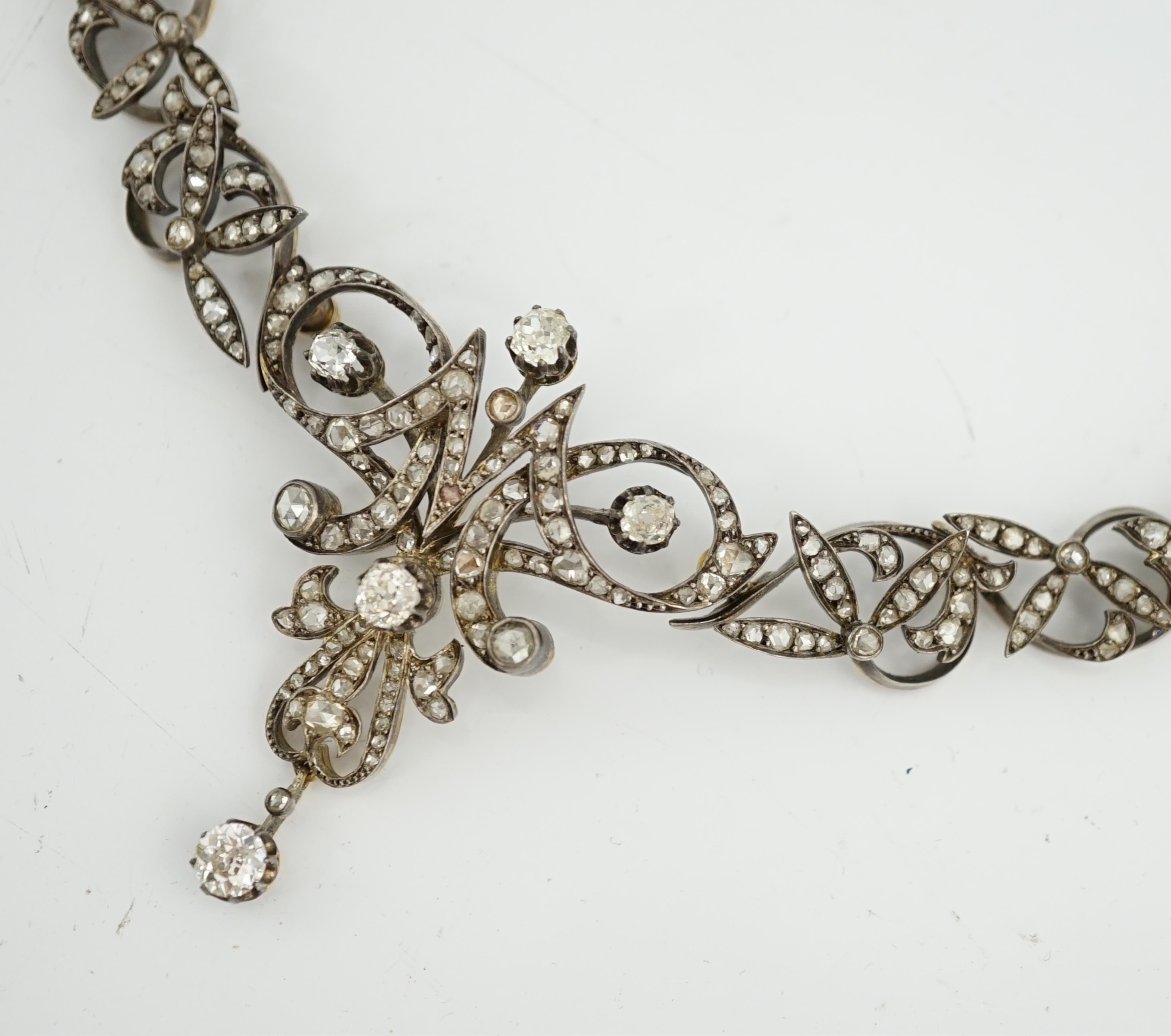 A late 19th/early 20th century French 18ct gold and silver, old mine and rose cut diamond cluster set tiara/necklace